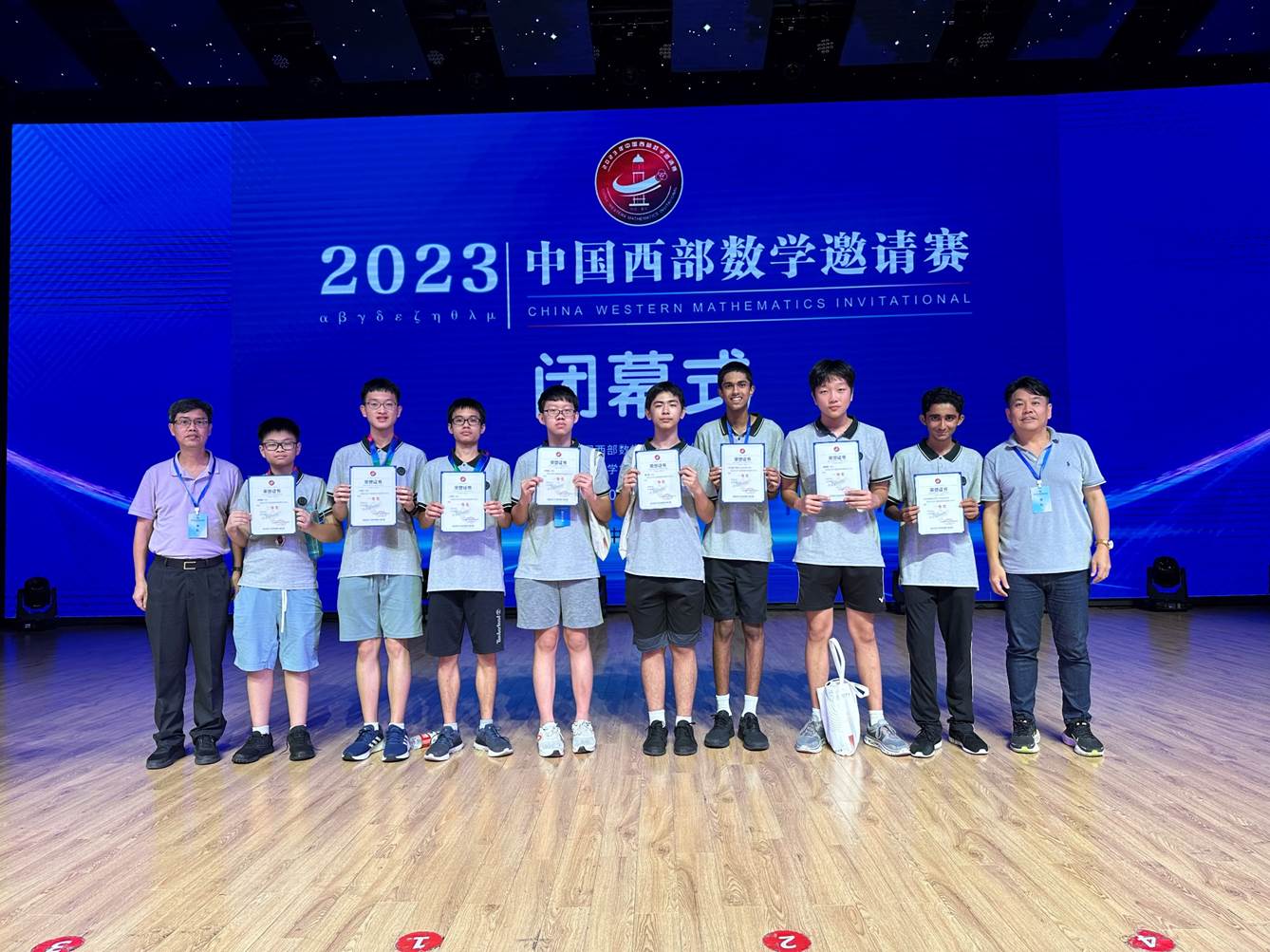 A group of people holding certificates